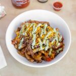 Island Fries <small>(Stir-fried angus beef with onions, tomatoes, parsley, shredded cheese, toppped with our green sauce.)</small>